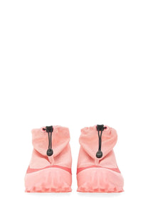 Pink soft-textured booties with black drawstrings and ruffled edge styled with mm6 maison margiela women’s cross low sneaker blue