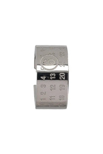 Silver-toned metal ear cuff by MM6 Maison Margiela with engraved calendar numbers and central circular emblem