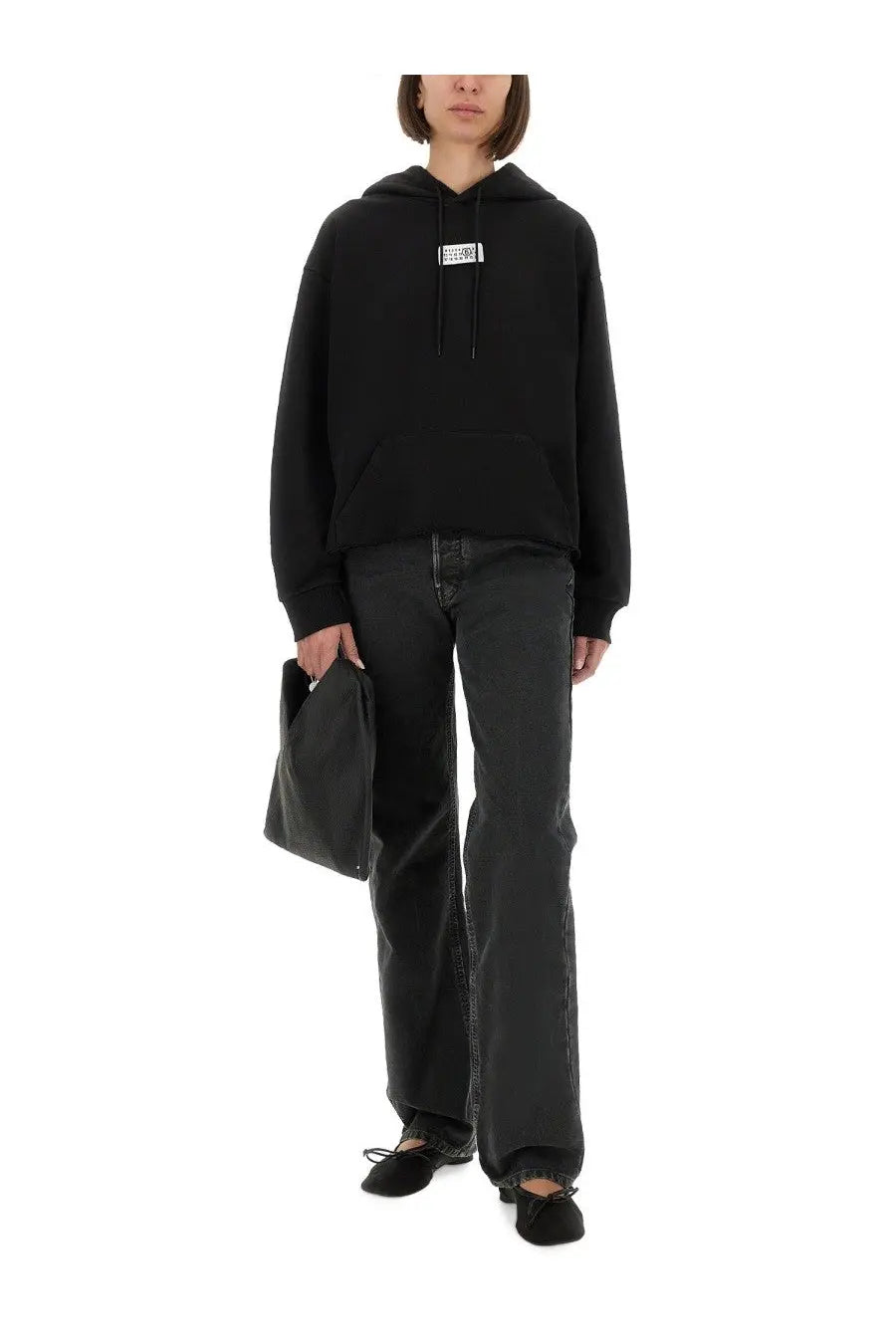 Black oversized cotton hoodie for women by MM6 Maison Margiela with a white rectangular logo patch on the chest