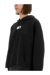Mm6 maison margiela women’s black oversized hoodie with white logo patch and matching drawstrings on the chest
