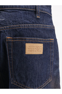 Dark blue denim jeans with tan leather patch featuring printed numbers and number 6 in a circle by mm6 maison margiela