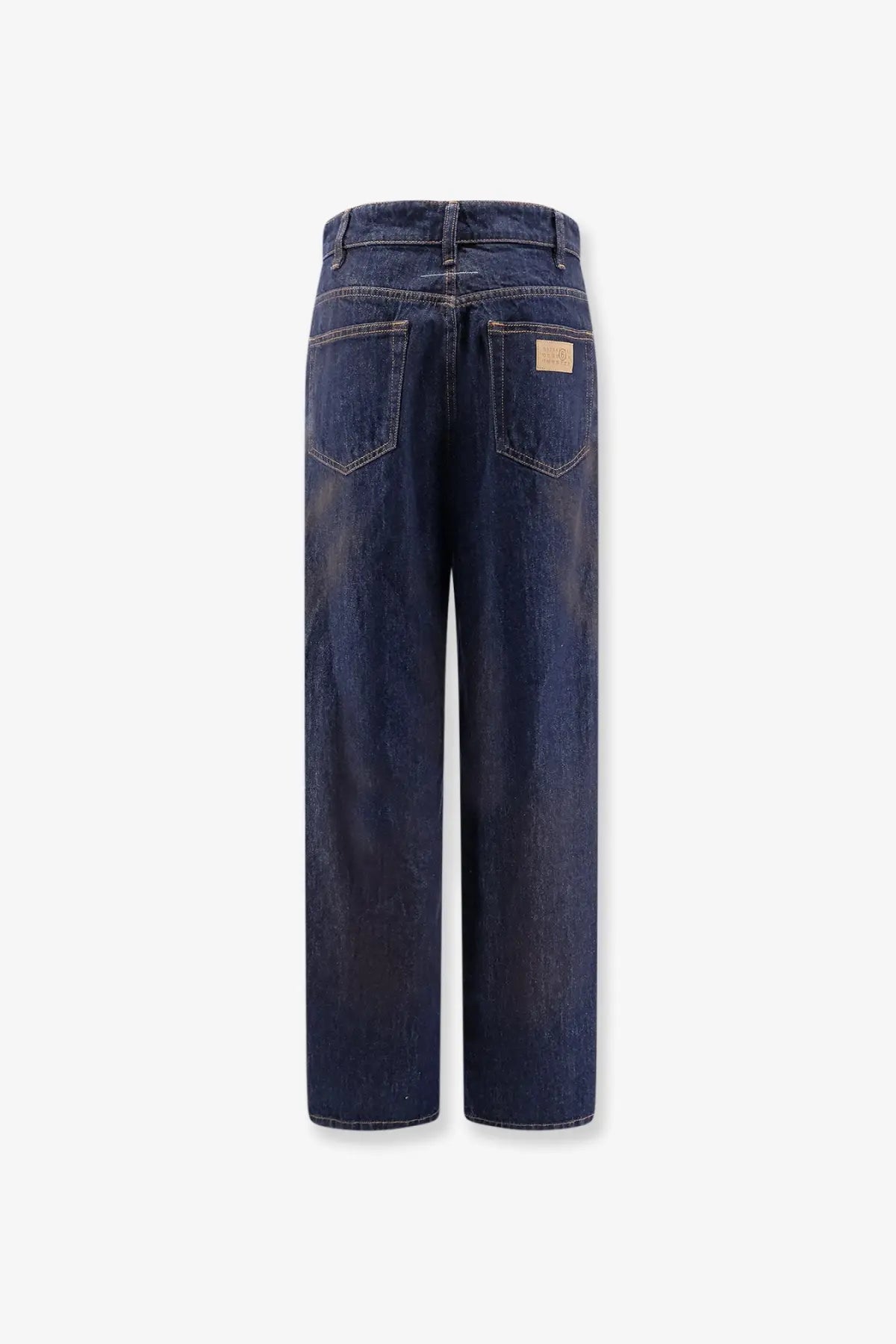 Back side of mm6 maison margiela women’s blue dark indigo denim jeans with straight-leg cut and brown leather patch