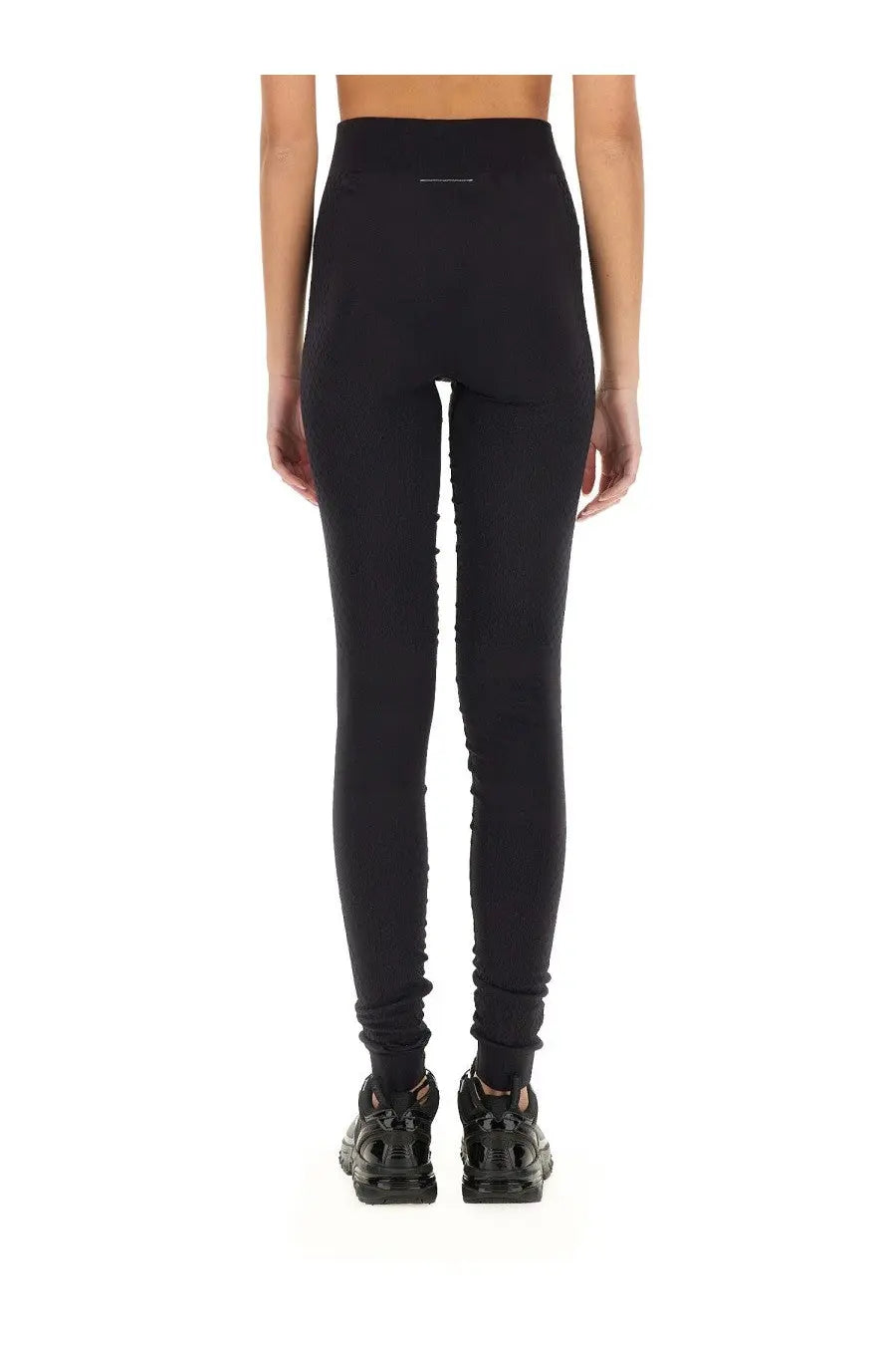 Black high-waisted mm6 maison margiela women’s leggings with sleek form-fitting design and subtle side seam detailing