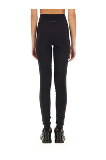 Black high-waisted mm6 maison margiela women’s leggings with sleek form-fitting design and subtle side seam detailing