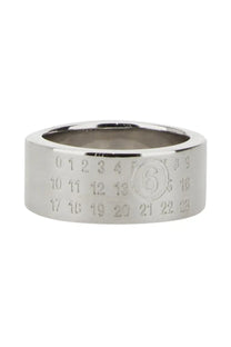 Silver-toned metal ring by mm6 maison margiela featuring an engraved calendar design and central circular logo