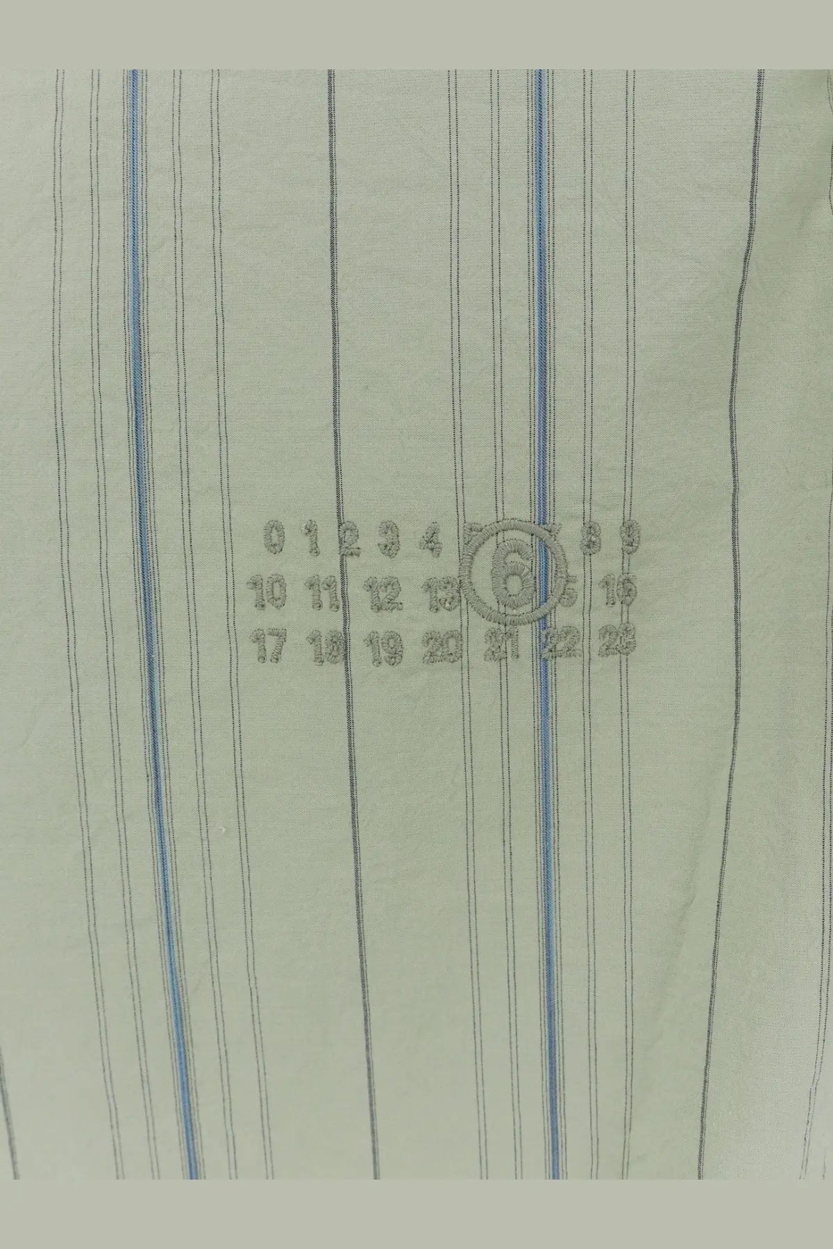 Mm6 maison margiela women’s striped cotton shirt in light green with thin blue and black vertical stripes and embroidered calendar design