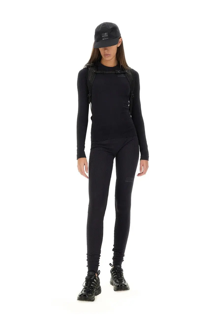 Black long-sleeved snug fit athletic top with subtle chest branding from MM6 Maison Margiela women’s tops black collection