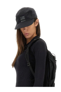 Black salomon cap with subtle white logo and gore-tex branding featured with mm6 maison margiela womens tops black
