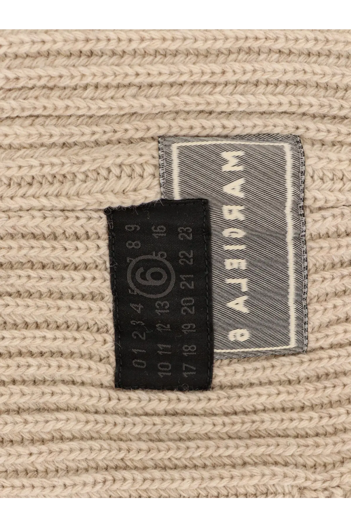 Beige ribbed knit wool blend sweater with black size tag and gray woven mm6 maison margiela label