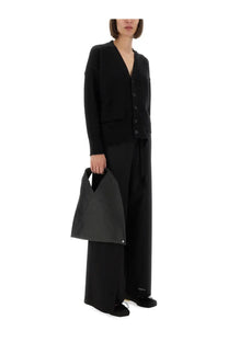 Black minimalist tote bag with structured geometric design and subtle texture paired with mm6 maison margiela wool knit cardigan