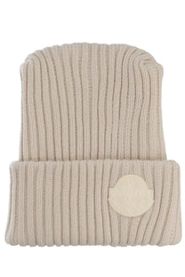Beige ribbed knit wool beanie with circular logo patch on folded brim from moncler genius men’s collection