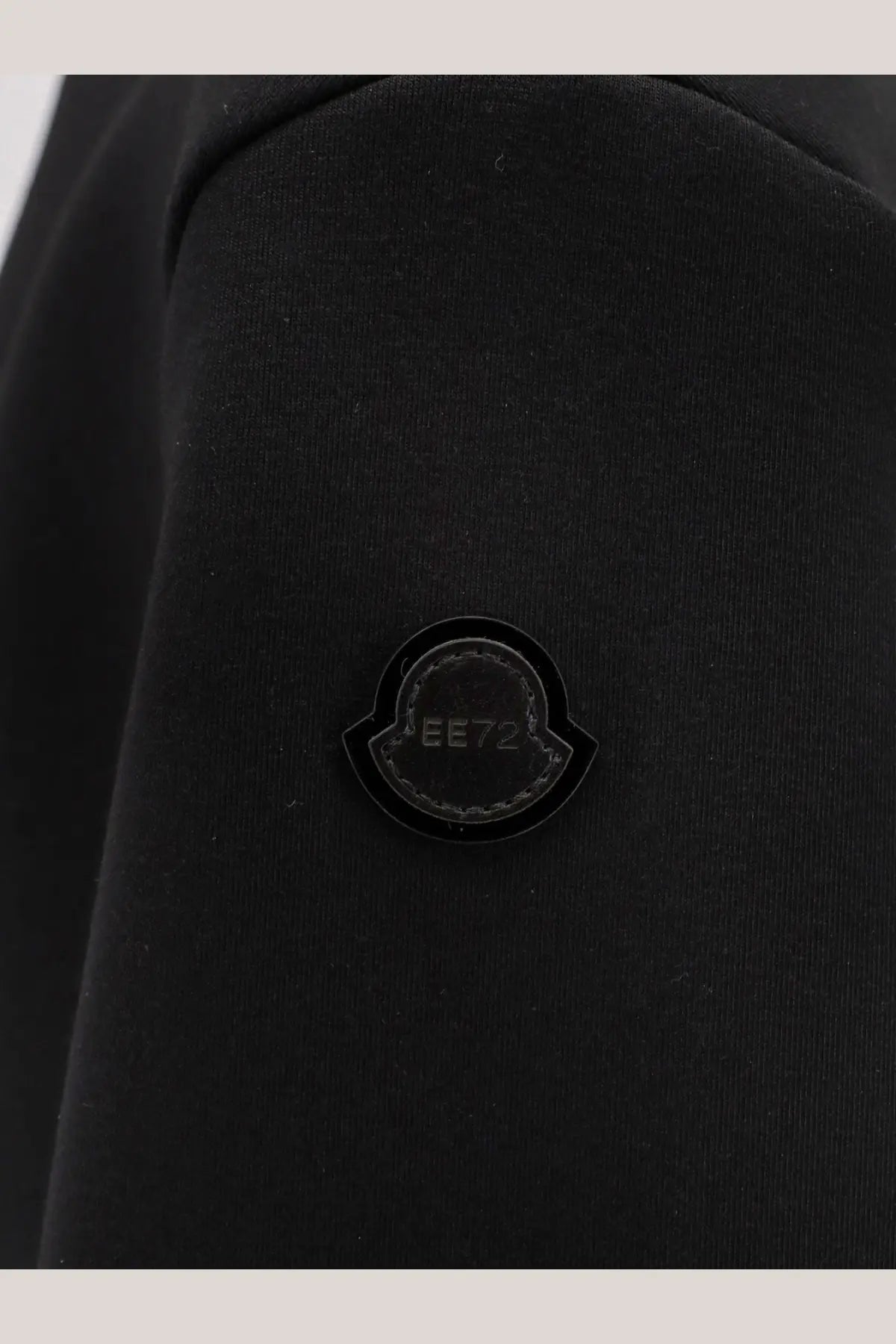 Black moncler logo patch with glossy finish and stitched edge on moncler genius women’s edward enninful wool turtleneck