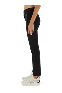 Black moncler grenoble women’s slim-fit pants with tapered design and subtle side zippers
