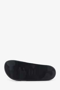 Moncler men’s Basile rubber slip-on sandal in black camouflage with textured sole and small rectangular brand label