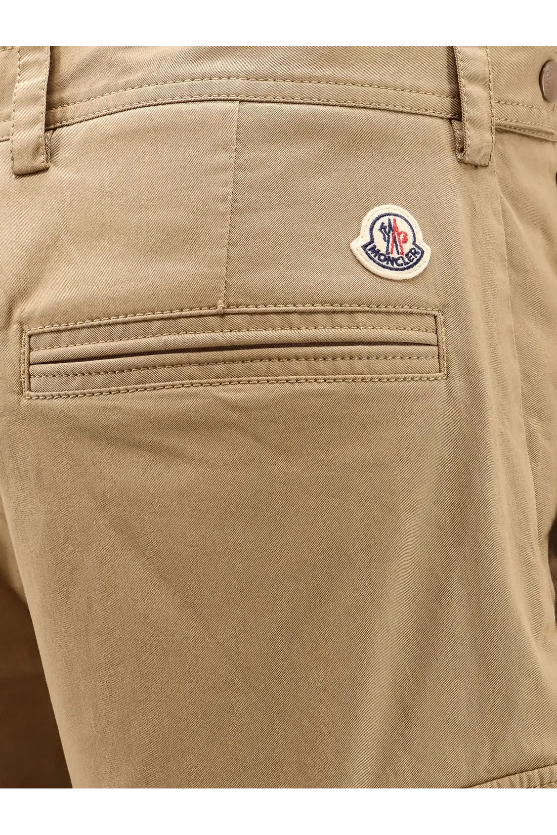 Beige moncler men’s cargo cotton chino shorts with subtle woven texture and logo patch on the back pocket backside view