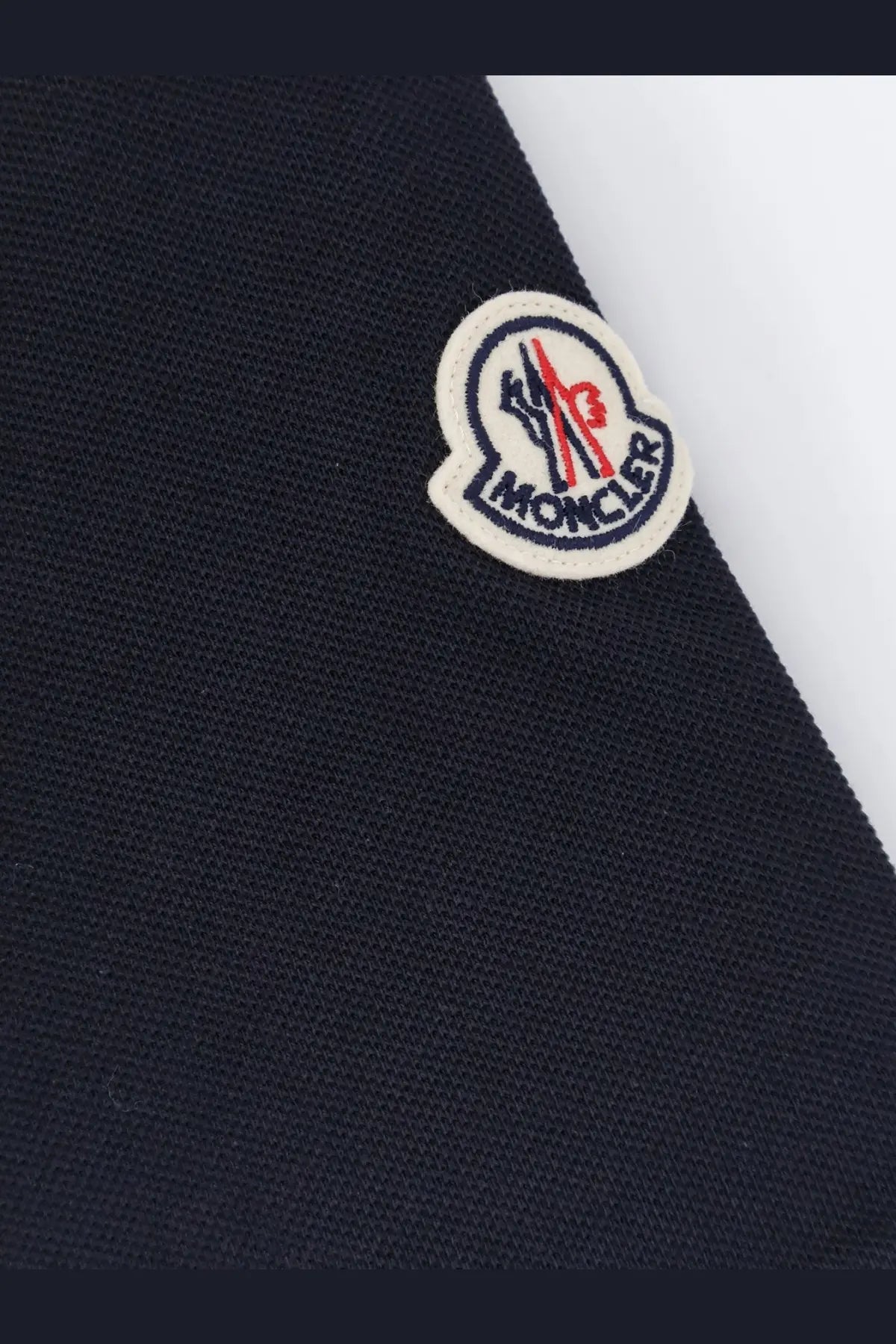 Dark navy blue moncler men’s cotton polo shirt with a classic embroidered logo patch in red white and black