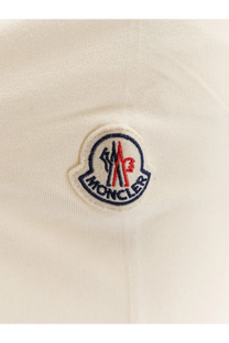 Cream-colored moncler logo patch with embroidered red blue and white details on moncler men’s white cotton shirt