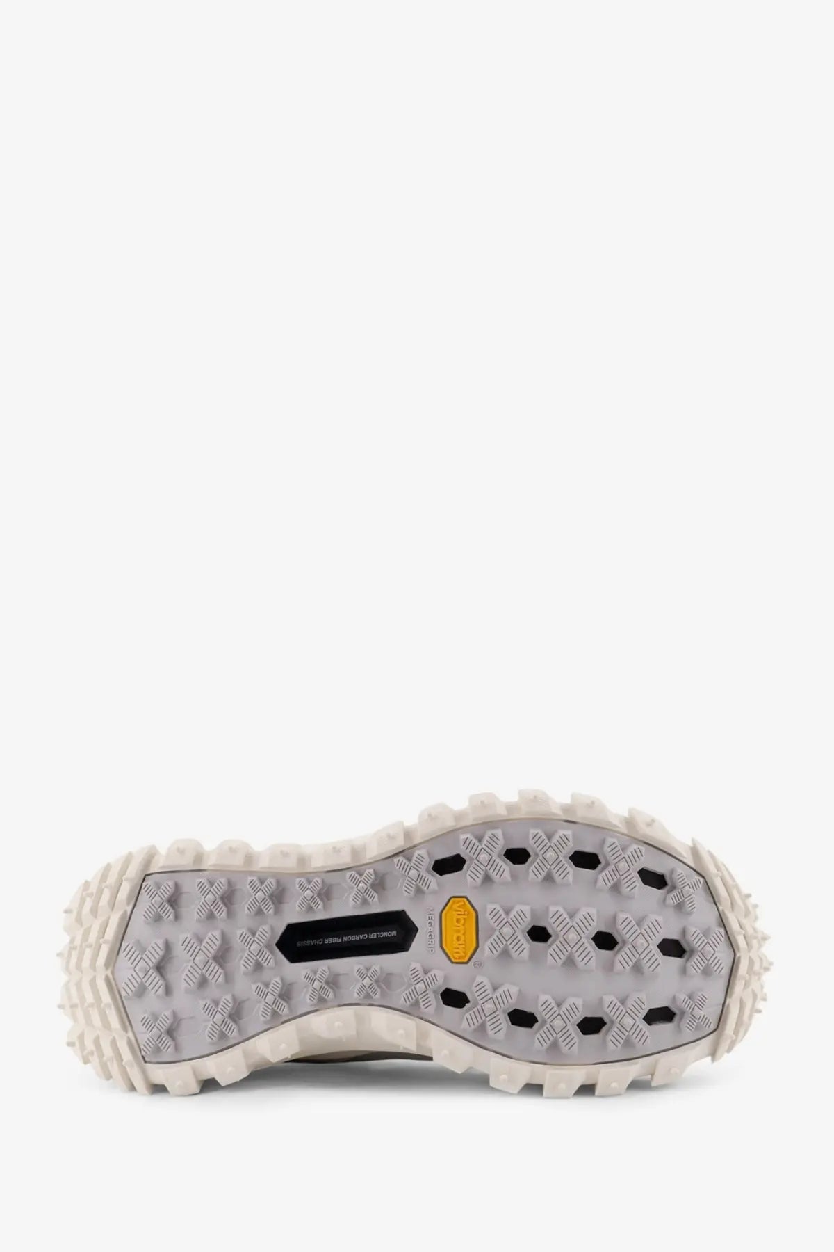 The sole of a gray moncler men’s trailgrip gtx leather and ripstop sneaker with a rugged tread and yellow vibram logo