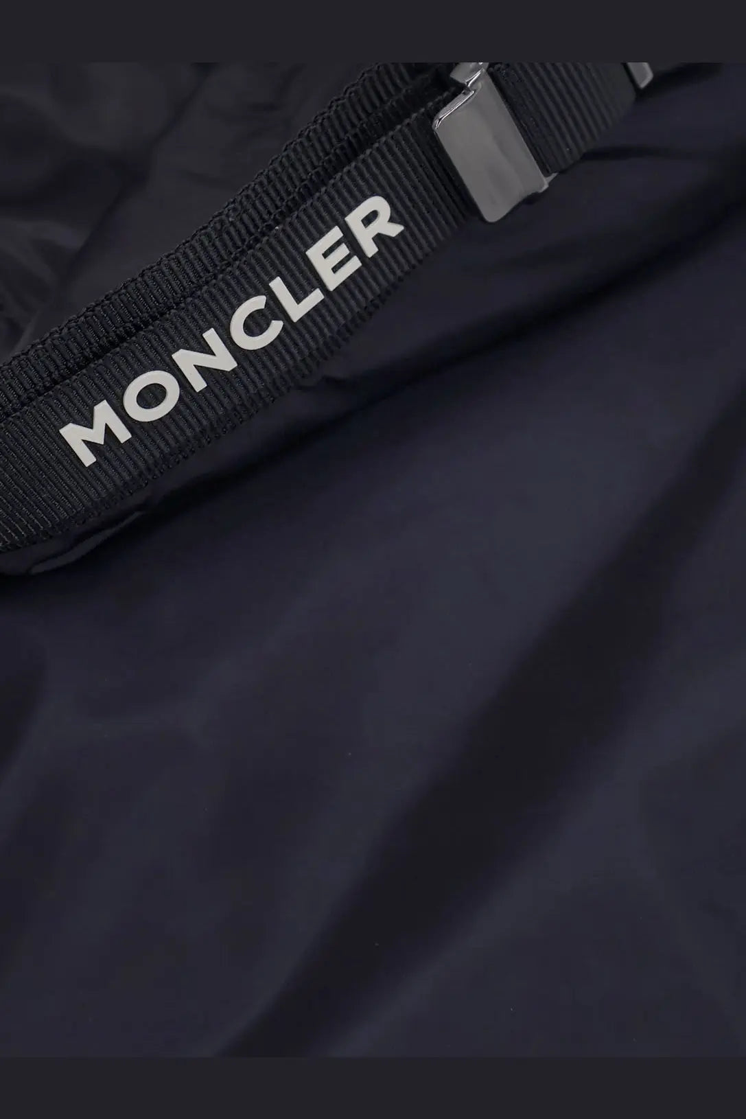 Black moncler branded strap with white lettering and metallic buckle on moncler men’s trestraou blue down jacket