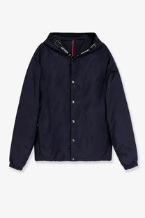 Moncler men’s trestraou down jacket in blue featuring a black hooded jacket with silver buttons and red collar stripe