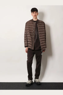 Brown quilted puffer jacket with zipper front and subtle geometric embroidery in moncler rick owens flight parka style