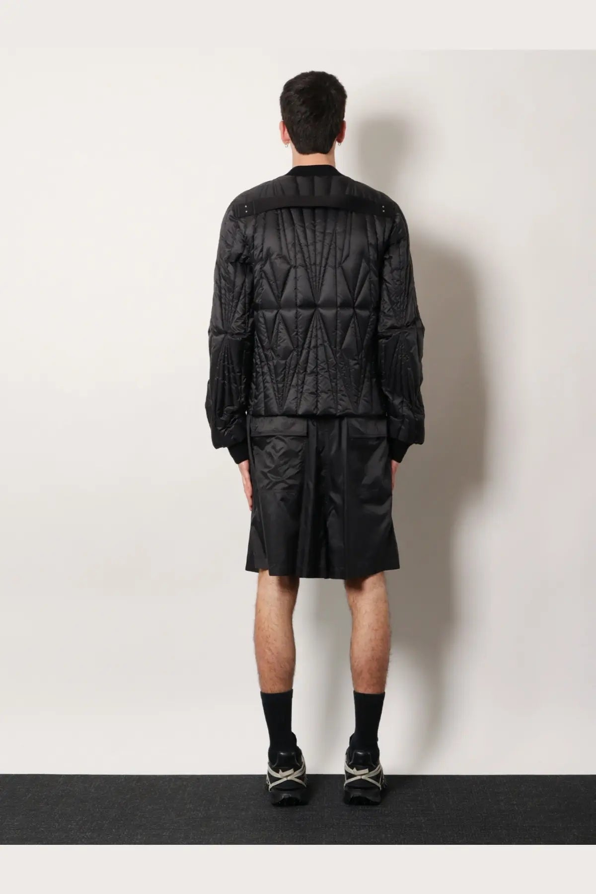 Moncler Rick Owens men’s black quilted bomber jacket with geometric stitching and modern structured silhouette