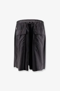 Moncler plus Rick Owens men’s black kiltshorts with drawstring waistband and large front pockets in glossy lightweight fabric
