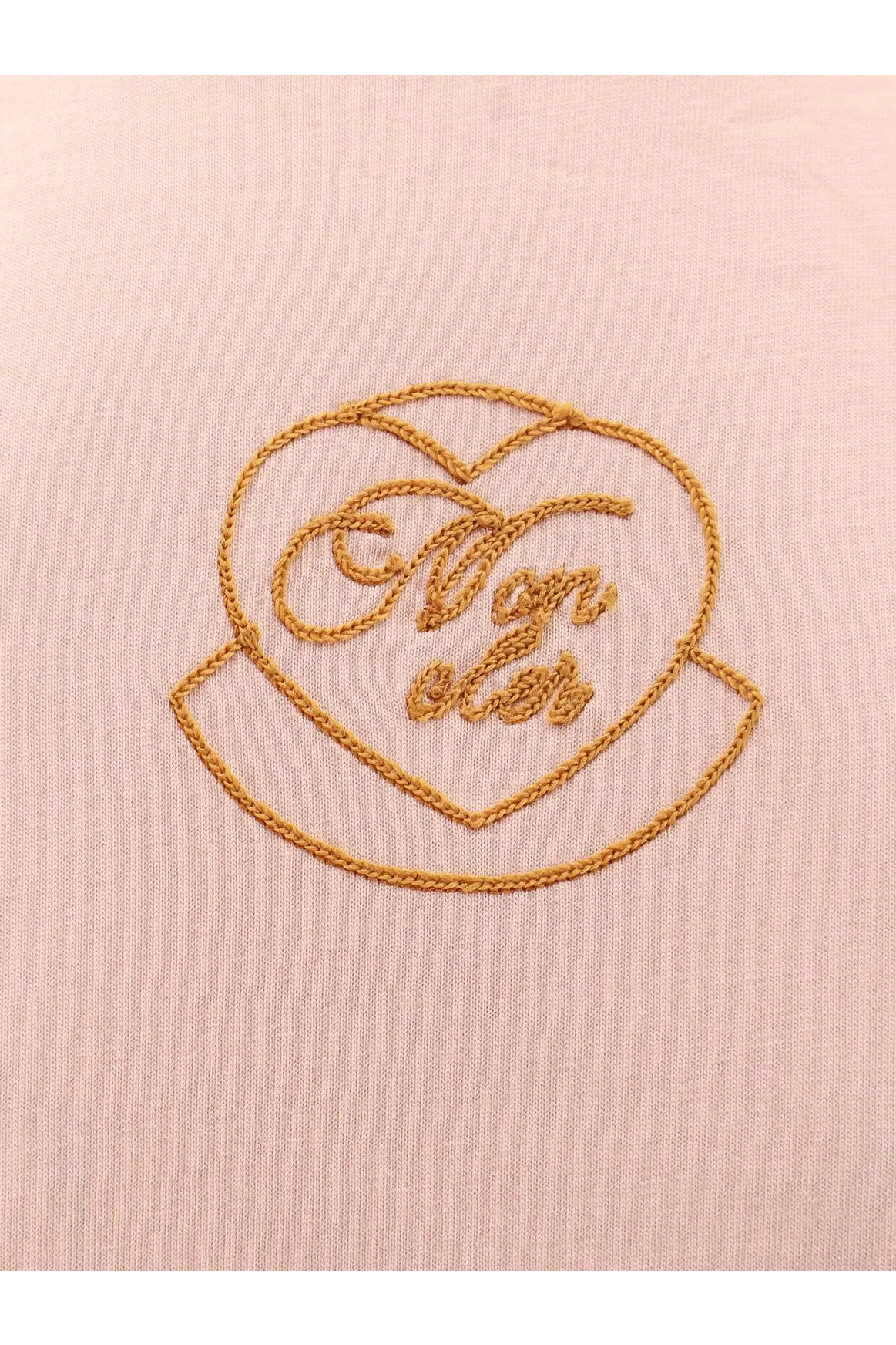 Delicate gold-thread embroidered heart-shaped bon élé logo on soft pink biologic cotton Moncler women’s shirt