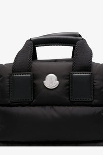 Moncler women’s Caradoc micro nylon shoulder bag in black with quilted puffer fabric leather patches and silver logo emblem