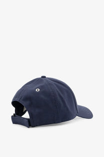Navy blue Moncler women’s cotton baseball hat with adjustable strap and white eyelet detail shown from the back side