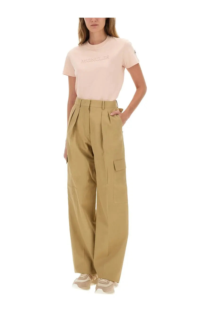 Beige high-waisted cotton cargo pants with pleated front and side pockets complementing moncler women’s blue shirt