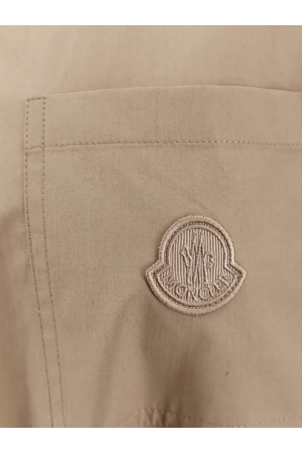 Beige moncler logo patch embroidered on a light fabric pocket of moncler women’s cotton shirt jacket beige