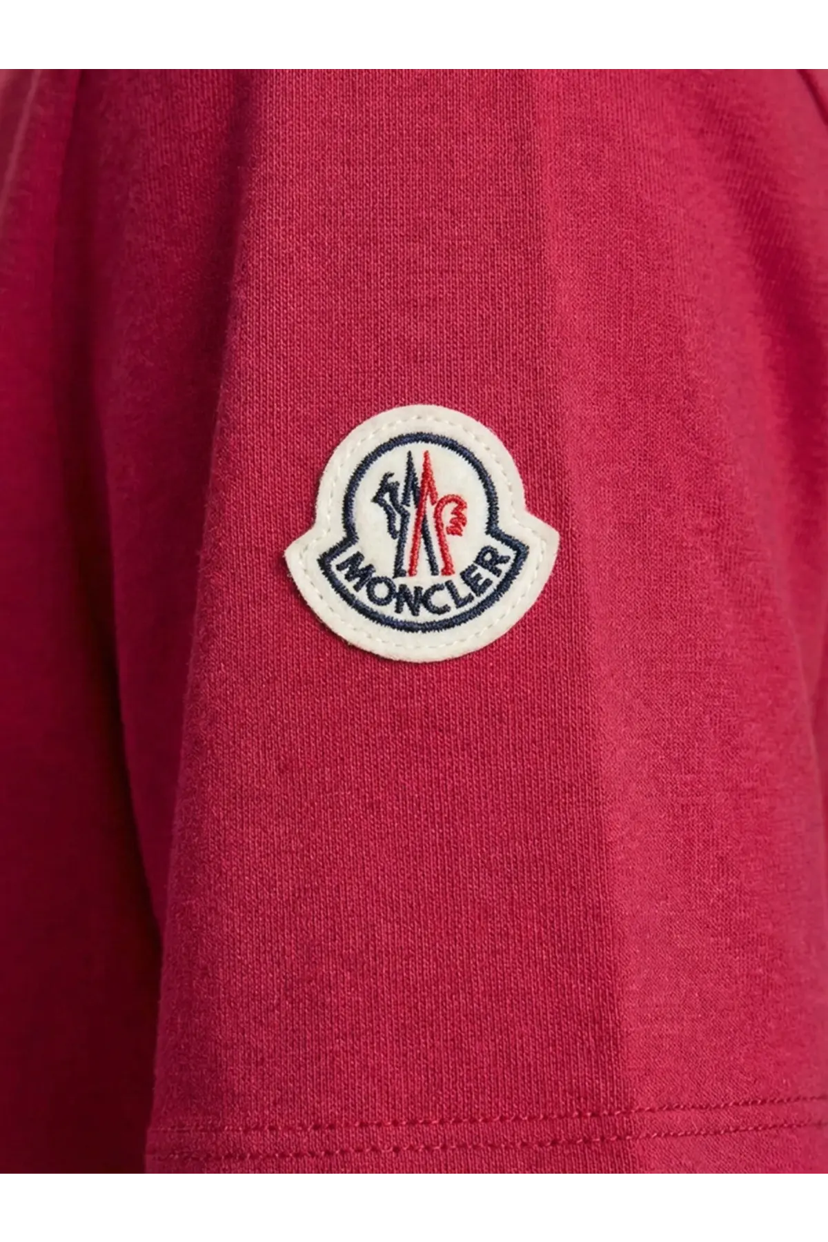 Red moncler logo patch on textured knit fabric of moncler women’s red cotton shirt