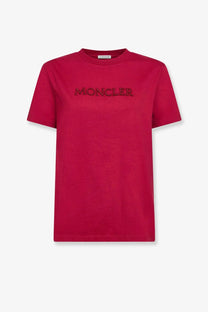 A vibrant red Moncler women’s cotton t-shirt with a bold embroidered logo across the chest