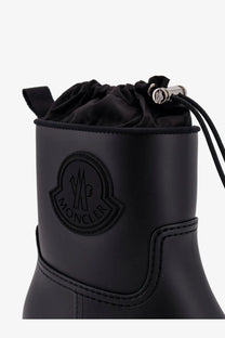 Moncler women’s black Kickstream rubber rainboots with drawstring closure and embossed logo on the side