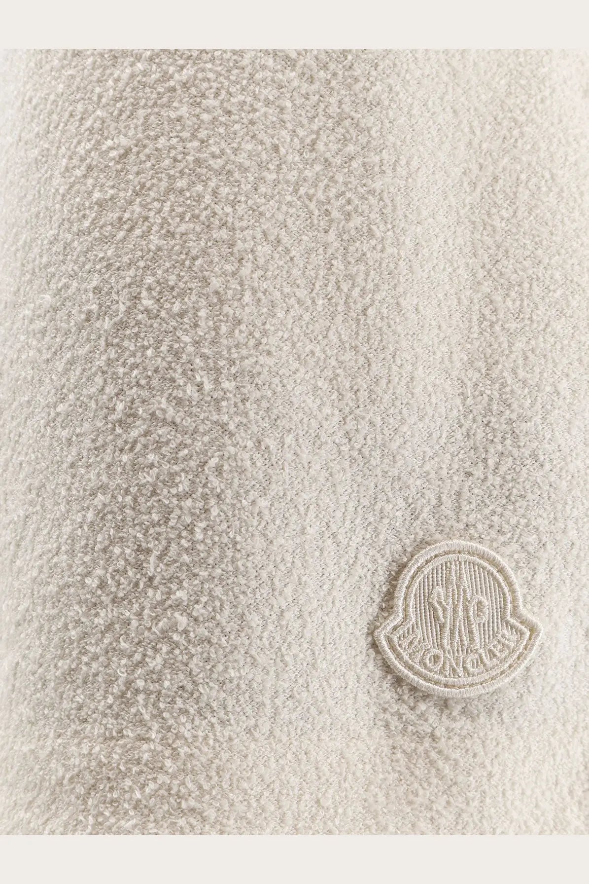 Beige textured wool coat with matching embroidered moncler logo patch shown with moncler women’s nylon shorts white