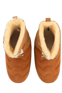 Tan suede moon boot unisex ankle boots with quilted wave patterns and plush cream shearling lining in beige