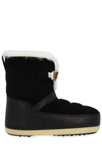 Black suede moon boot unisex snow boot with white faux fur lining and tan toggle closure for winter wear