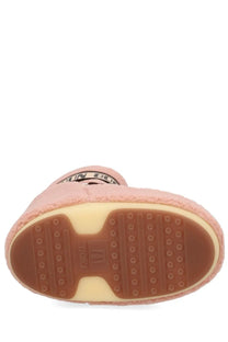 Pink fluffy moon boot with brown rubber sole and beige midsole shown from the back for unisex use