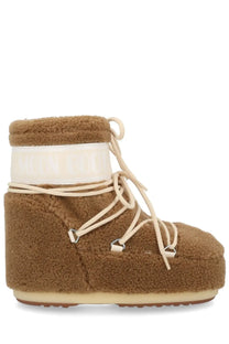 Moon boot unisex icon low fleece boot in brown with tan fuzzy material cream laces and white logo band around ankle