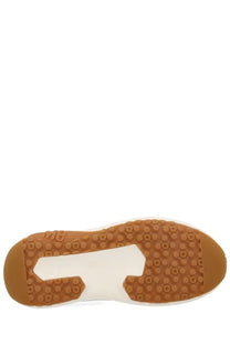 Tan rubber sole with white midsole and circular tread pattern on moon boot unisex sneaker beige