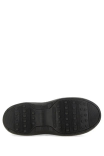 Black rubber sole of moon boot women’s moon boot black with textured tread pattern and embossed brand name in center