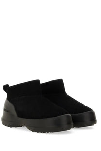 Moon boot women’s black suede ankle boots with chunky rubber sole and pull tab shown from the back side