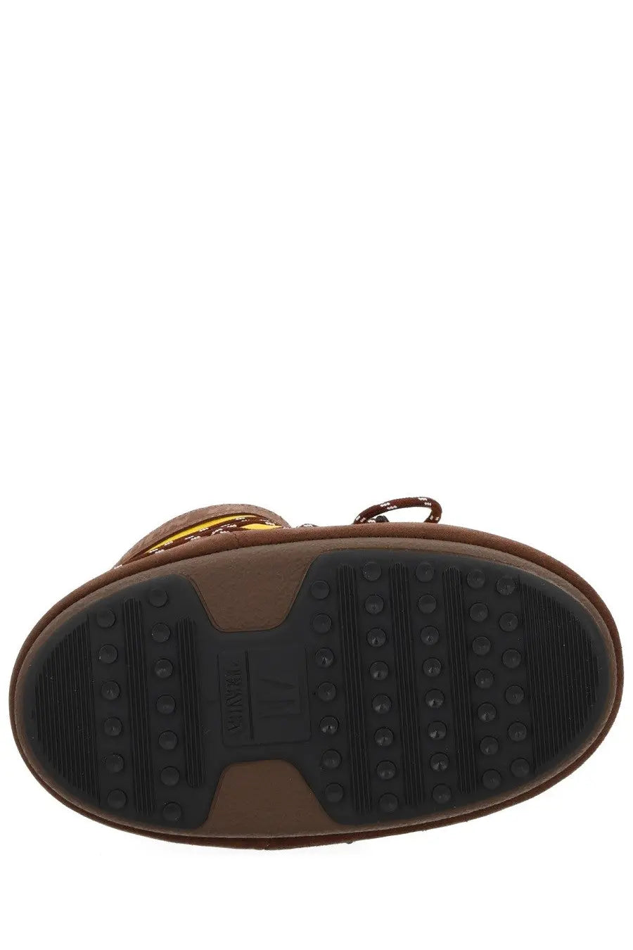Back side of brown leather moon boot with black rubber sole and circular tread patterns from moon boot women’s guest in residence boot yellow