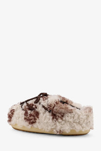 Cream and brown curly wool slip-on mule shoe with braided laces from moon boot women’s low faux fur sandals pattern