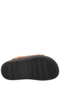 Moon boot women’s shearling sandal brown with black rubber sole textured grip and tan faux fur trim visible from the back