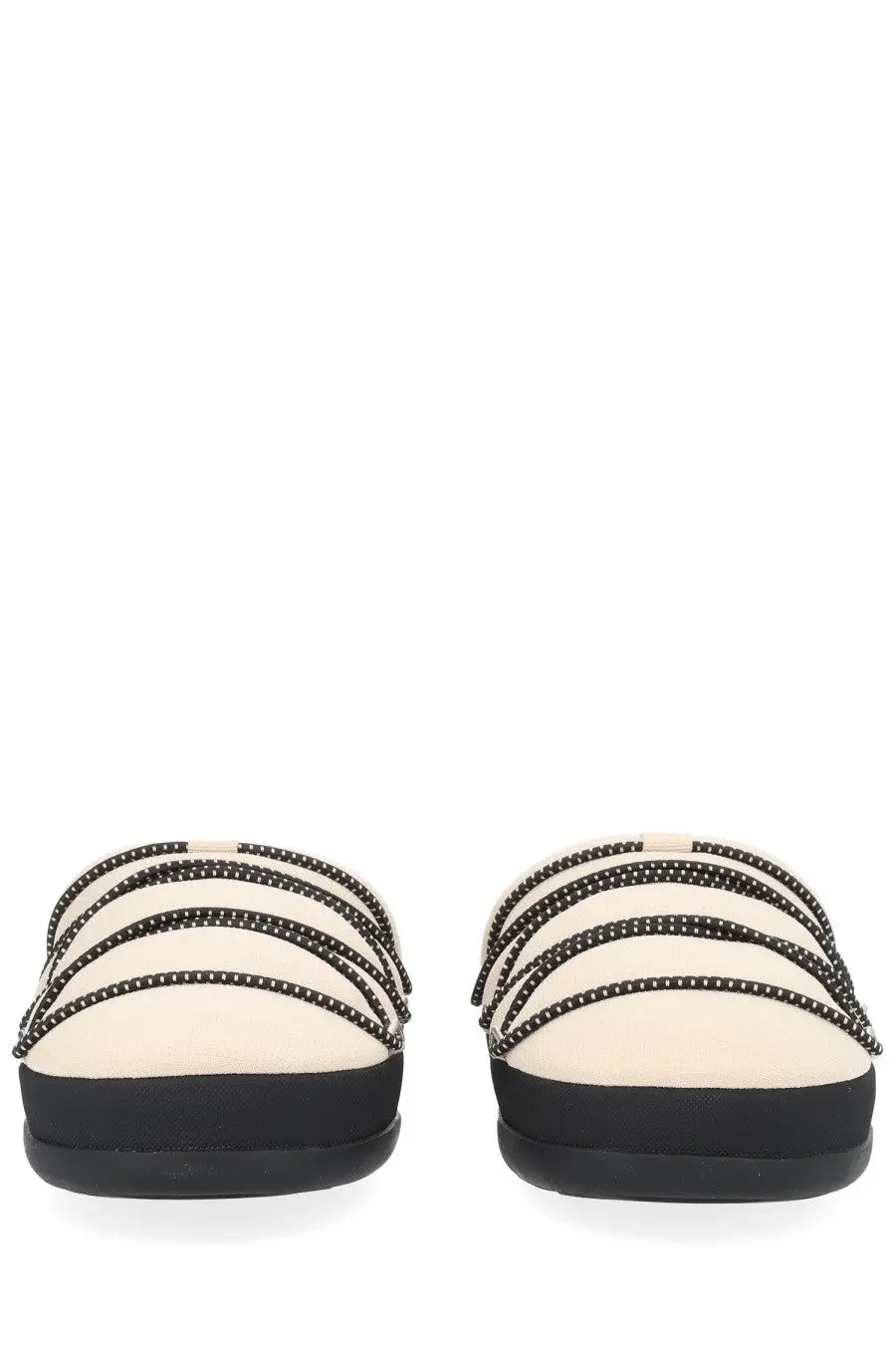 Cream-colored moon boot women’s soft slipper slide sandals with black studded straps and thick flat black sole
