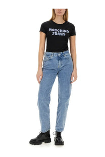 Black Moschino jeans t-shirt with white sequin Moschino jeans logo paired with blue boyfriend pants for women