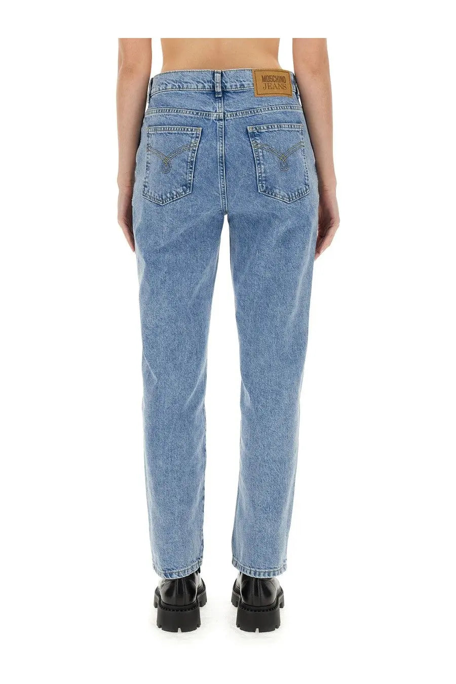 Light-wash Moschino jeans womens boyfriend pants with classic straight-leg cut and brown leather brand patch at waistband