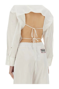 Back view of moschino jeans women cotton shirt white featuring a white cropped blouse with back tie-up and sheer panels